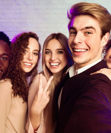 Millennial People Making Selfie Having Fun On Corporate Party Indoors